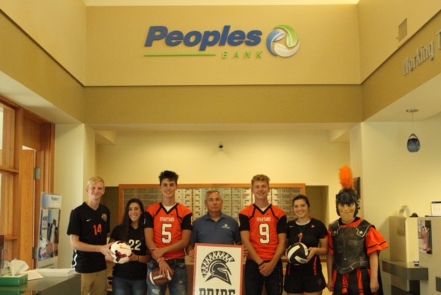 people wearing jerseys and holding sign